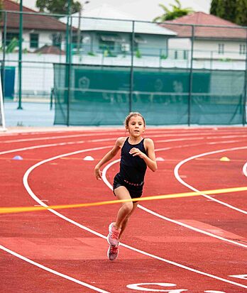 Brighton College Vibhavadi pupil running in an athletics event, promoting endurance and determination through sports education.