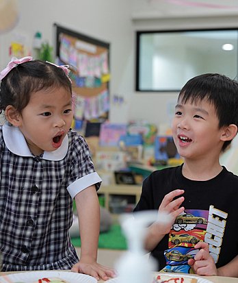 Pupils developing communication skills and expanding their knowledge through language learning in an international education environment.