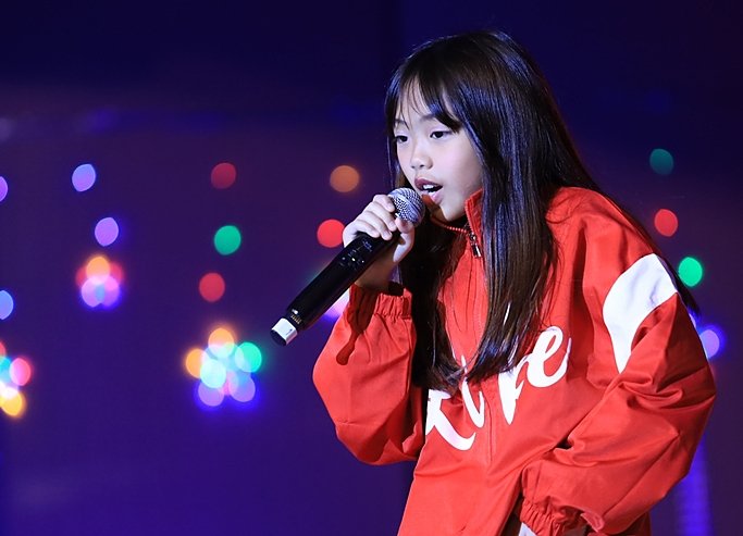  Prep pupils confidently performing on stage at Brighton College Bangkok Vibhavadi during a school event 