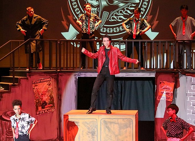  Boy dancing on stage at Brighton College Vibhavadi, expressing confidence and creativity through performing arts education. 