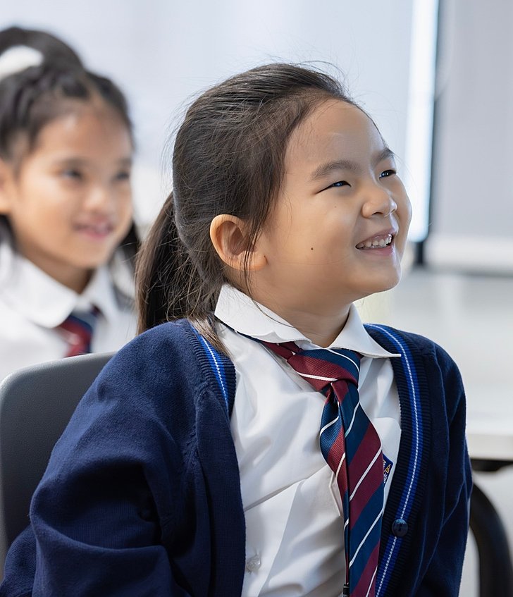  Prep pupils confidently answering a teacher’s question and smiling at Brighton College Vibhavadi, a top international school in Bangkok 