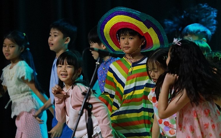 Year 3 and Year 4 pupils bringing global cultures to life through music as part of their British curriculum learning. 