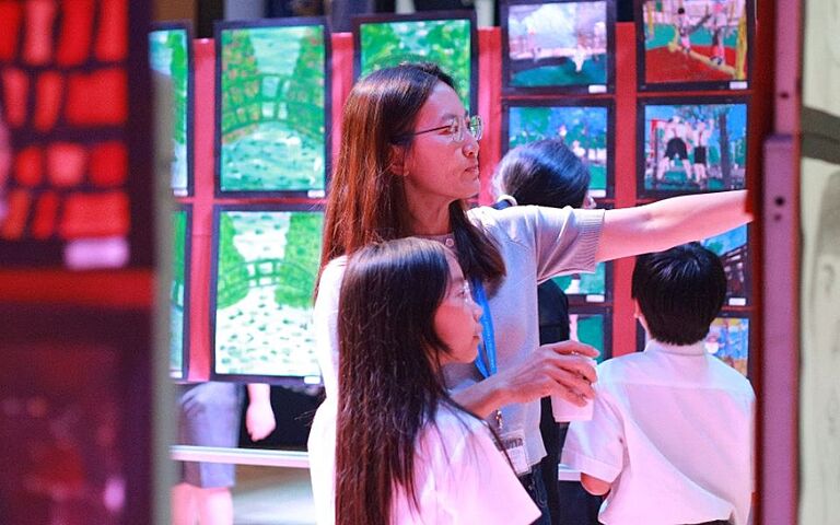  Year 5 pupils showcasing their artistic development through a creative arts exhibition inspired by their British curriculum learning. 