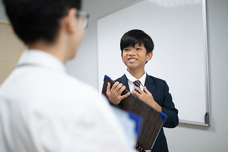  Boy presenting to classmates at Brighton College Vibhavadi, where new pupils thrive in a dynamic learning environment. 