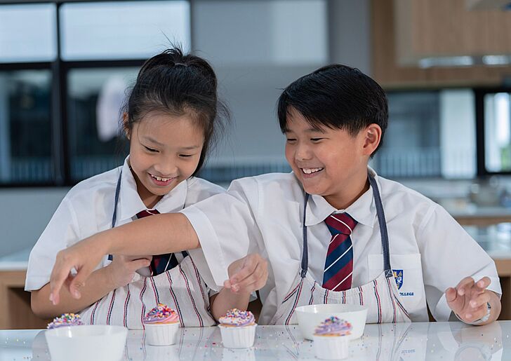 Prep pupils practising practical skills during a cooking class at Brighton College Bangkok 