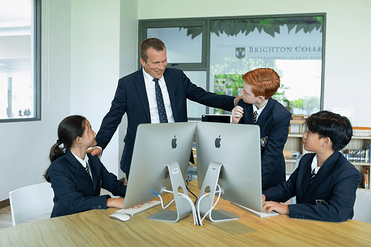  Brighton College Vibhavadi senior pupils standing together discussing 