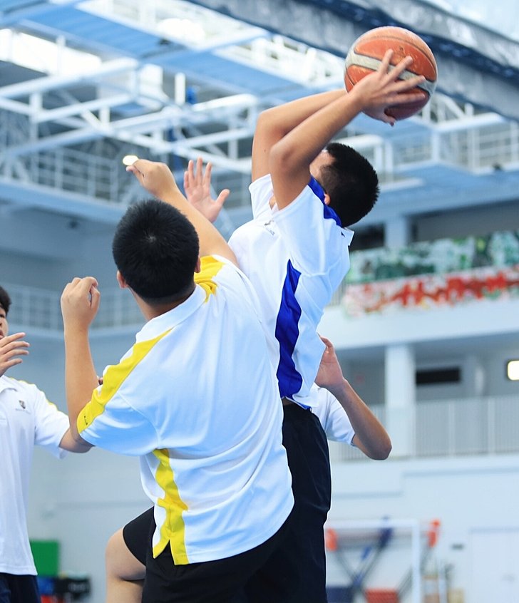  Pupils playing basketball as part of the Sports Scholarship programme at Brighton College Vibhavadi, a leading international school in Bangkok 