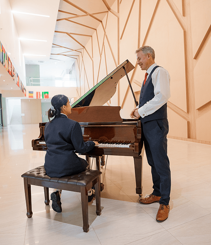  Specialist teacher leading a piano lesson at Brighton College Vibhavadi, nurturing musical talent through high-quality performing arts education. 