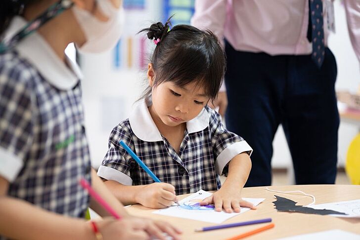  Pupil colouring a picture at Brighton College Vibhavadi, engaging in creative learning beyond the classroom at a leading international school in Thailand. 